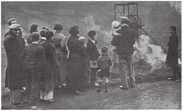 Relatives wait at pithead for news of miners conducting a stroke below